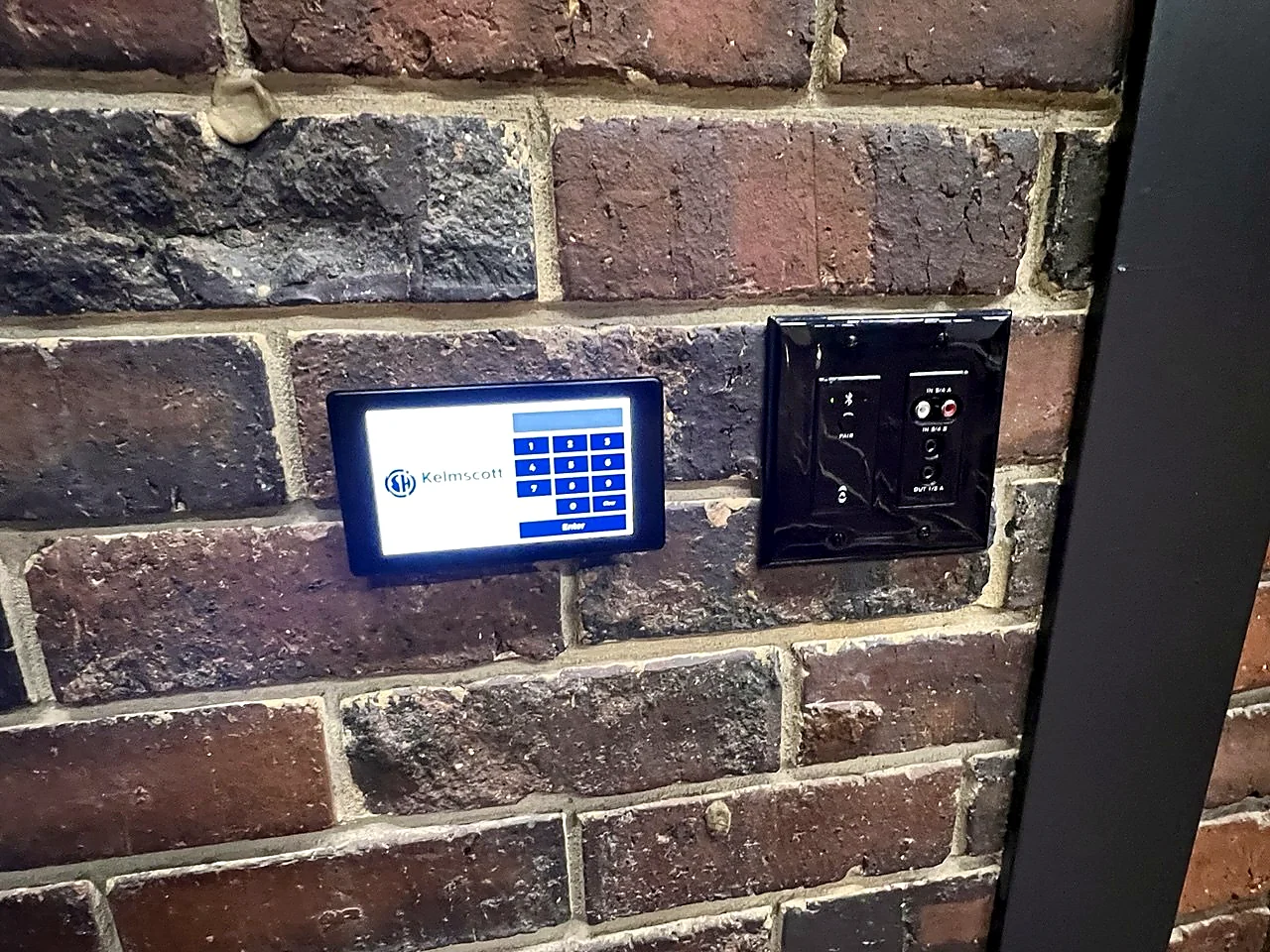 Wall-mounted AV control panel with labelled controls